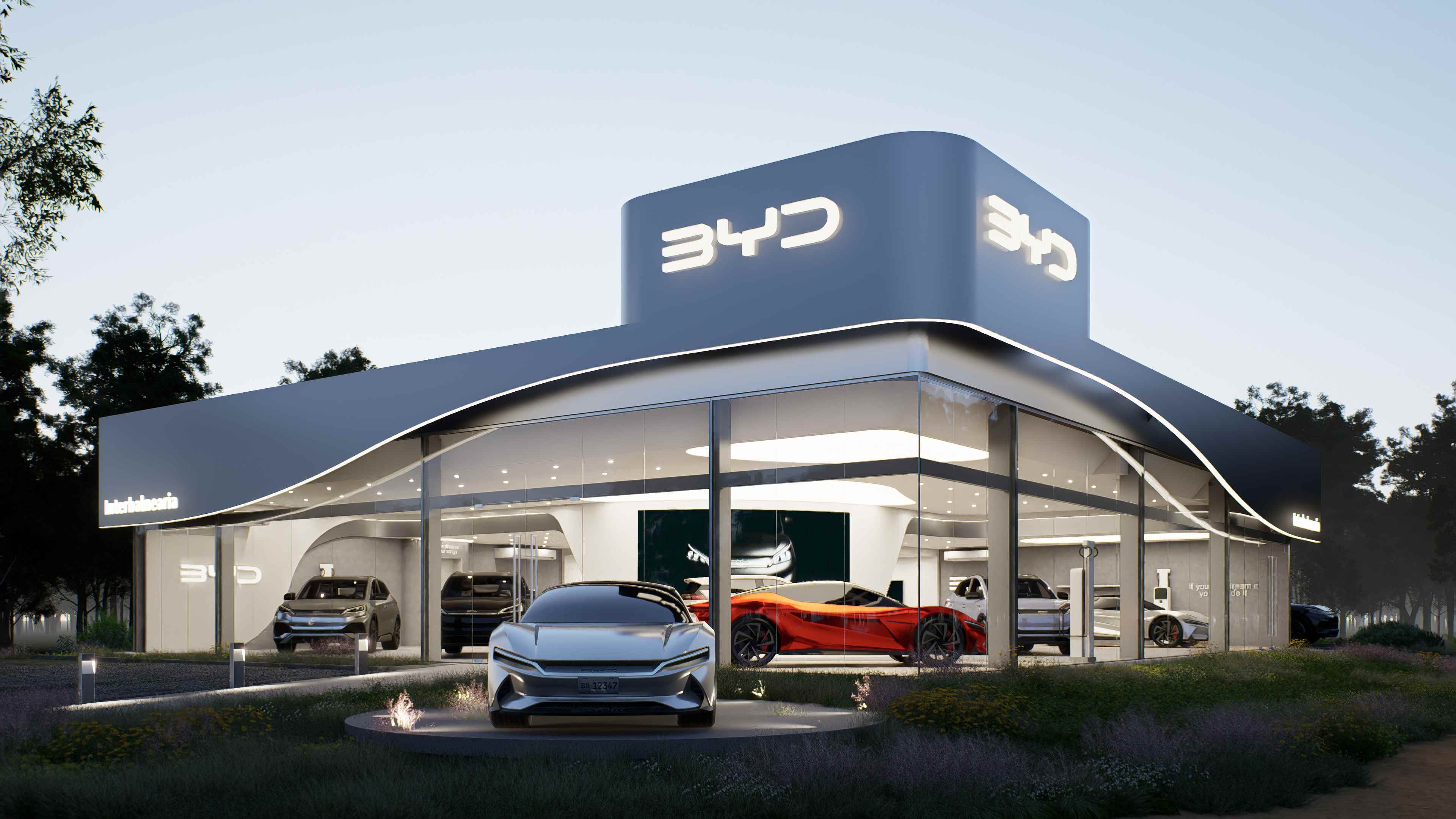 Vista nocturna de la fachada curva y el showroom vidriado de BYD Interbalnearia