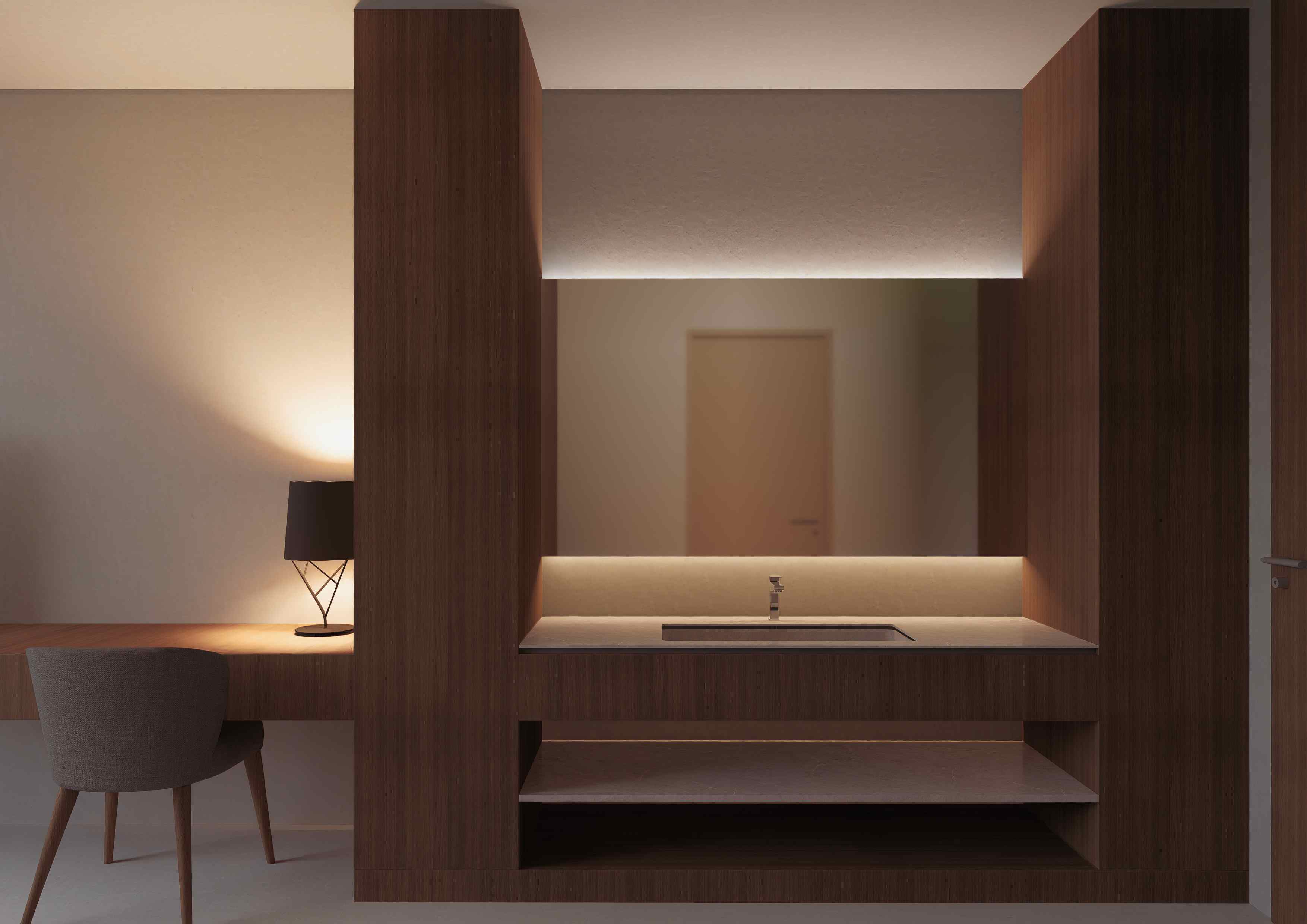 Detalle del dormitorio con mueble de madera, mesada, espejo iluminado y escritorio