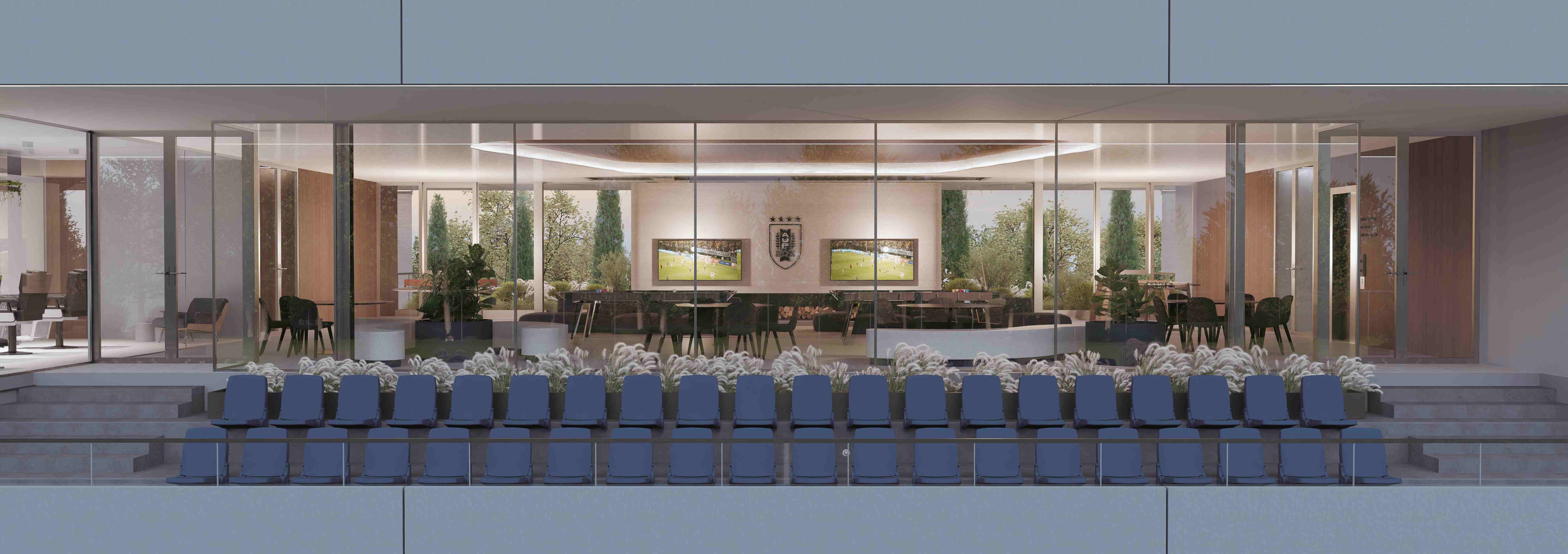 Vista frontal de los palcos con butacas azules frente a la sala de entretenimiento