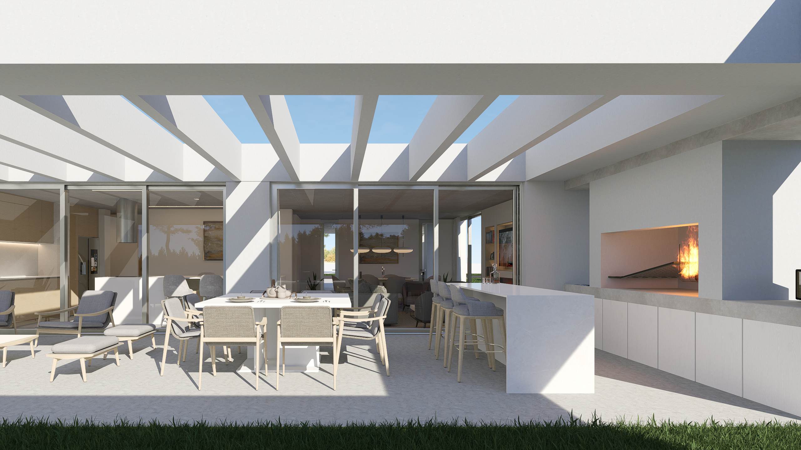 Galería con pérgola, zona de estar, barra y parrillero frente a los ventanales de la cocina y el comedor